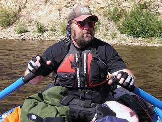 man sitting in a small raft with two oars man sitting in a small raft with two oars