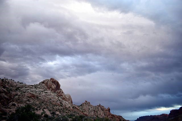 gray storm clouds over red rocks