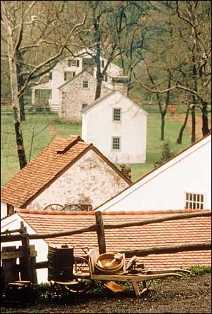 Photo of old stone houses surrounded by trees. National Park Service photo.