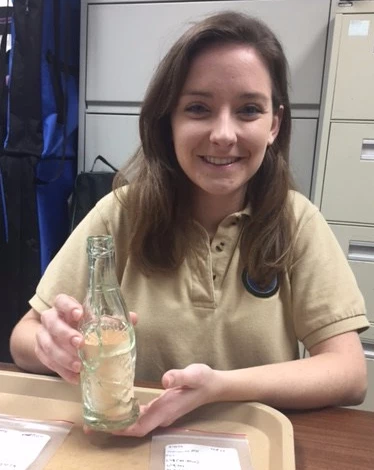A college student VIP reconstructing a glass soda bottle for photographing A college student VIP reconstructing a glass soda bottle for photographing