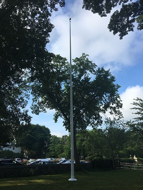 ADAM Flagpole Flagpole without the flag next to a parking lot
