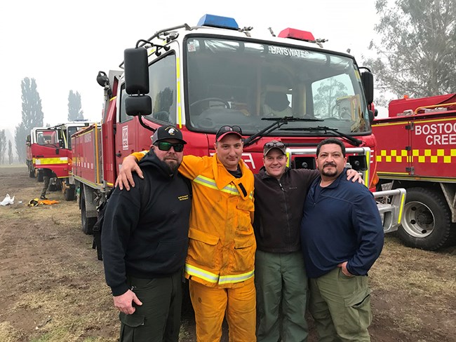 Australia Response - Scott Ebel with Engine Crew A group of men in front of fire trucks.