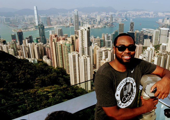 Aaron Adams with the Hong Kong skyline