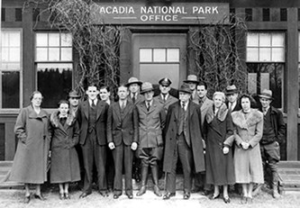 A group of people stand in front of a building at Acadia National Park