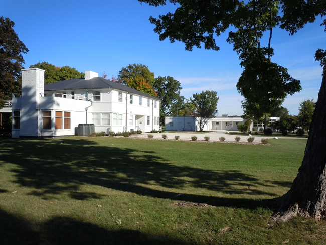 Adlai E. Stevenson II Farm Two-story white house with a green lawn and trees.