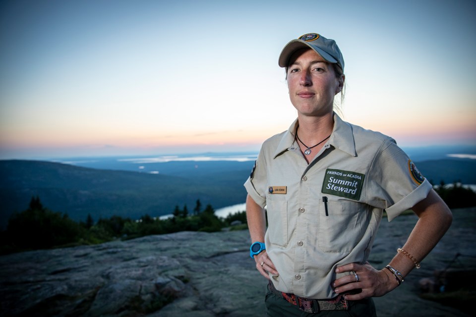 Woman in uniform in an open vista in falling light