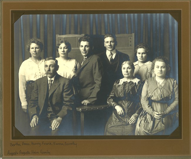 formal family photograph, mother, father, and six adult children