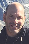 Face of Brian Gregory with mountains in the background