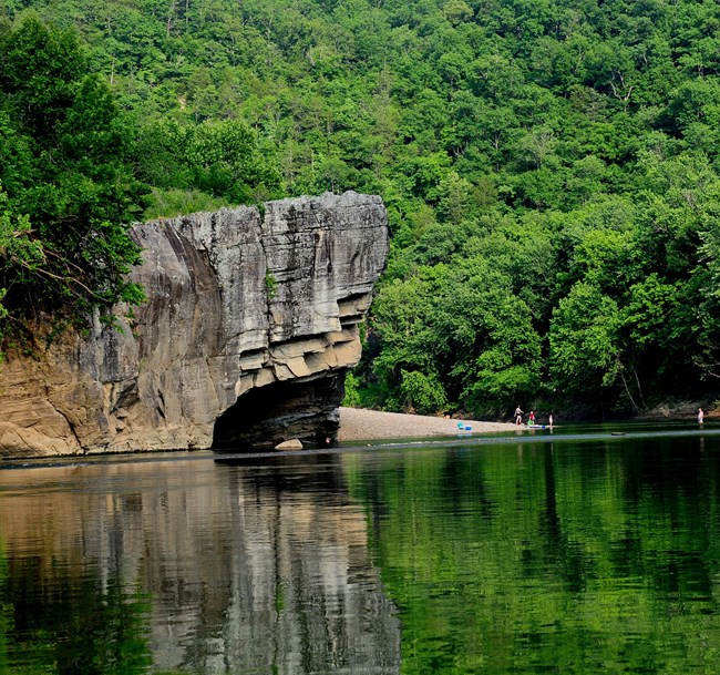 river with rock outcrop beyond