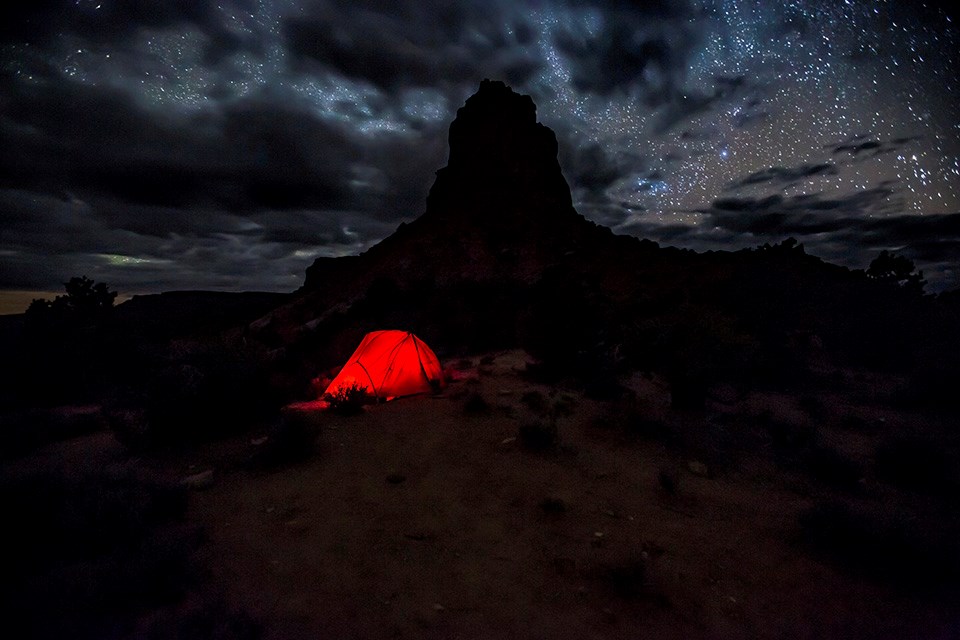 Night sky camp Night photo of tent lit from within, starry sky.