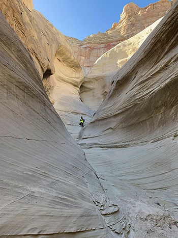 Dawn Davis 2018 Person standing in back of pale narrow sandstone canyon