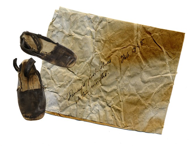 Baby Fan shoes, with note Baby fan shoes, with note marking the milestone of baby Fan's first walk in shoes