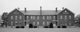 Fort Des Moines Barracks B&W photo of a two-story brick building.