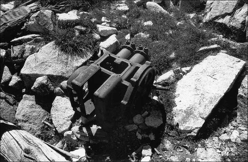 Remnants of an industrial motor next to large rocks