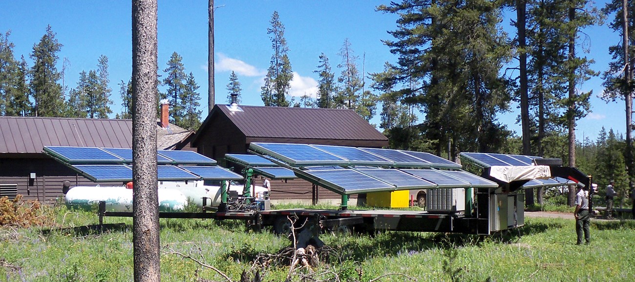 Trailer supporting photovoltaic panel array behind the Bechler ranger station. Trailer supporting photovoltaic panel array behind the Bechler ranger station.