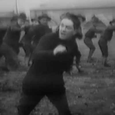 Boxing at Camp Sherman A man standing in a boxing position with many other men behind him