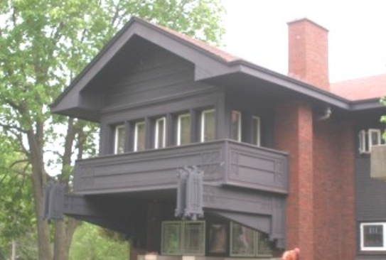 Bradley Residence Dark blue house with a brick chimney.