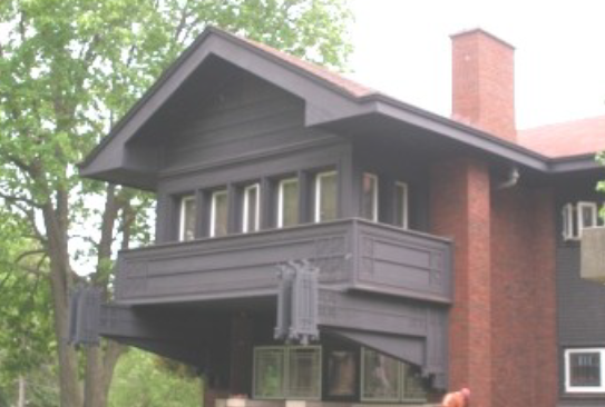 Dark blue house with a brick chimney.