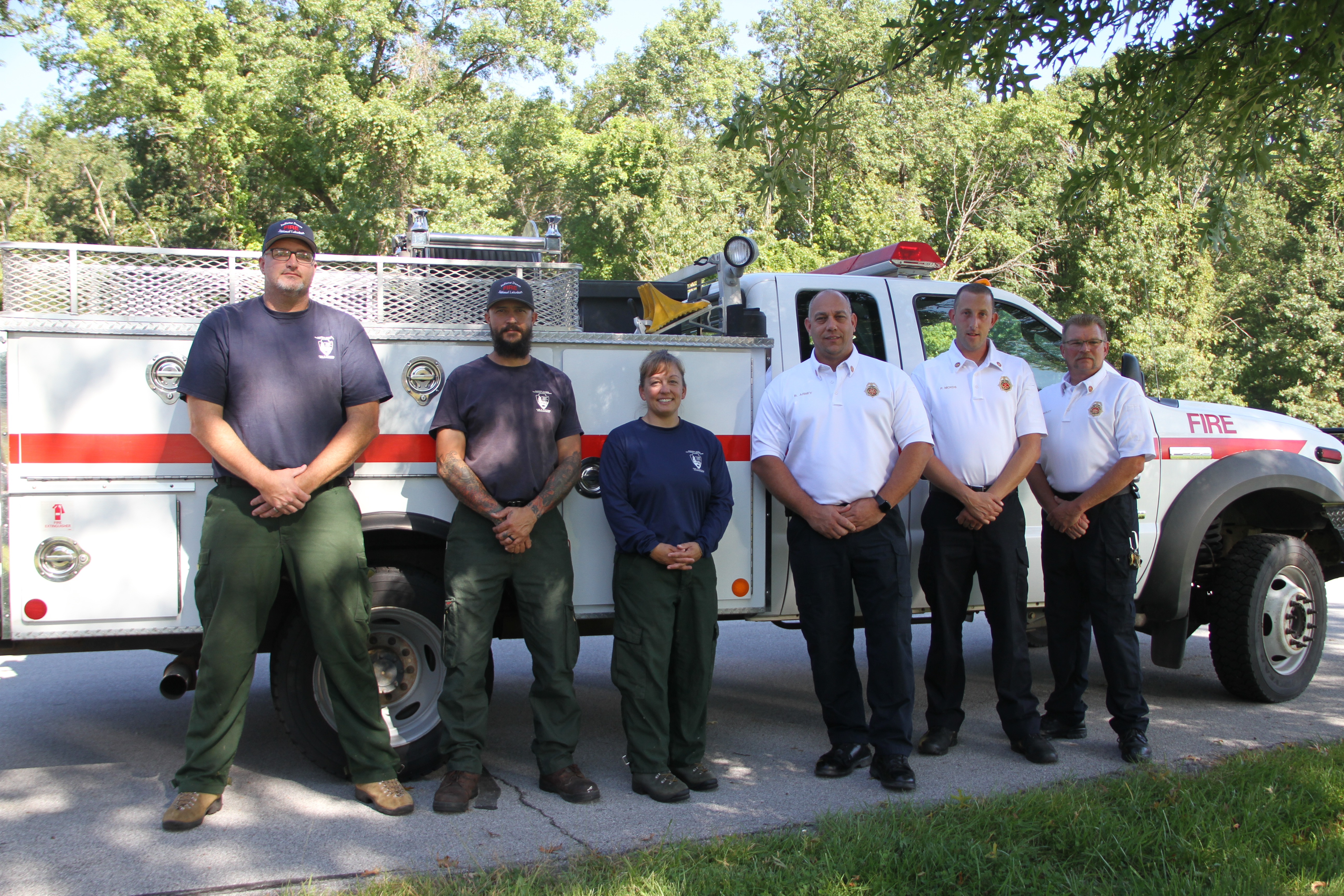 Burns Harbor and Indiana Dunes firefighters standing in front of donated fire engine.