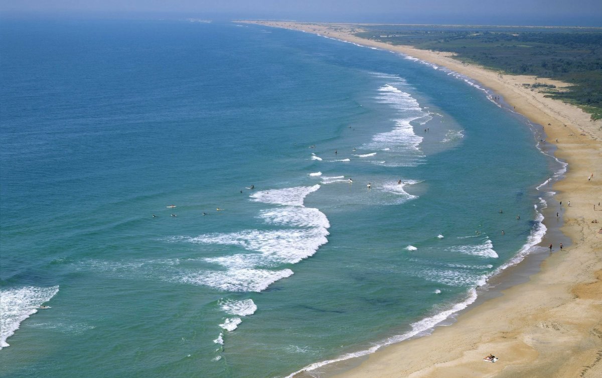 waves breaking along a sandy beach