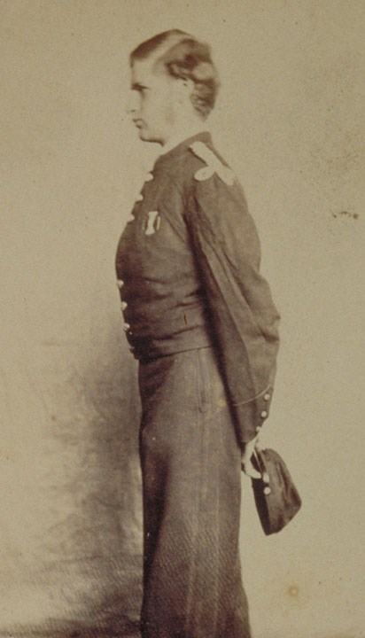 lt= Young man in Civil War uniform standing in profile holding hat in hands behind back