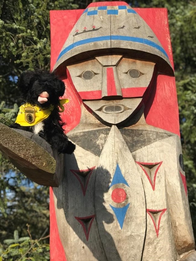 CBM2 toy dog near a wood carving