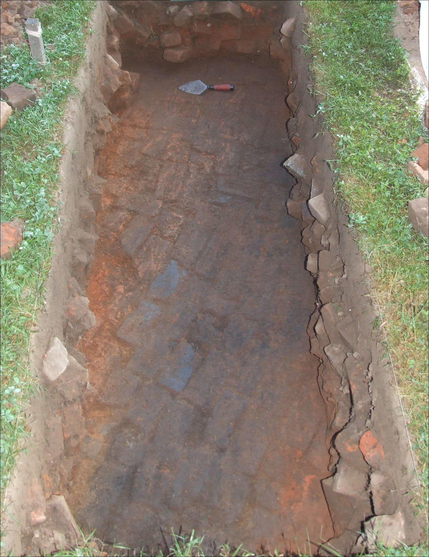 Remains of a brick clamp. The dark streak is ash left by the fire that baked the bricks.