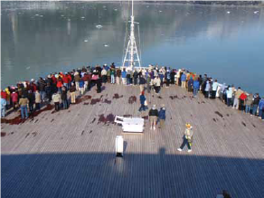 the bow of a cruise ship with visitors on it in Glacier Bay National Park