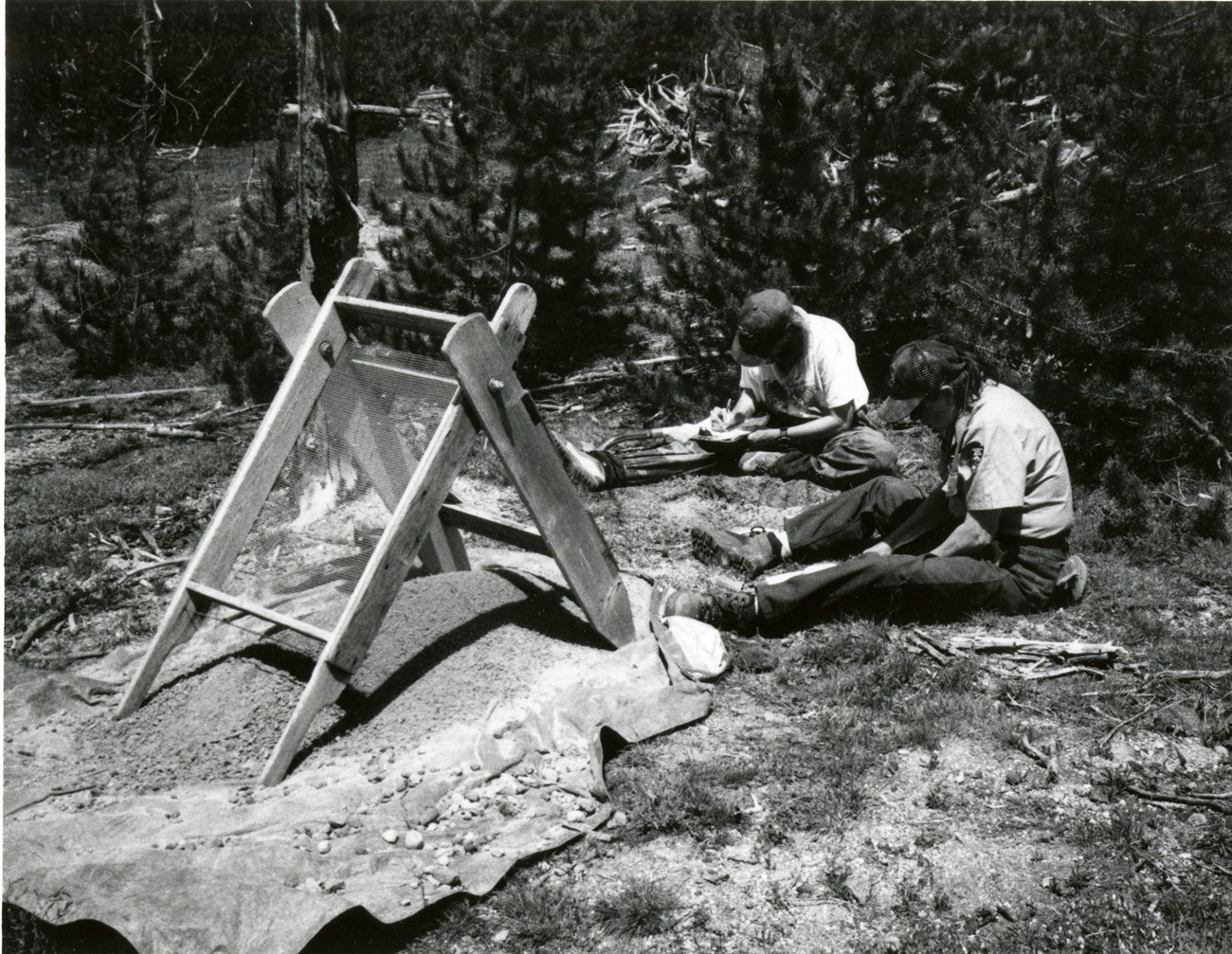 Two archeologists work on a road project excavation