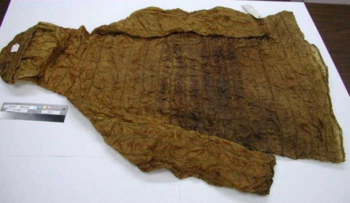 Dark staining and embrittling of a gut skin parka that is not typical of others in the collection. The exact cause is unknown, but anecdotal information suspects it is the result of the use of a leather dressing.