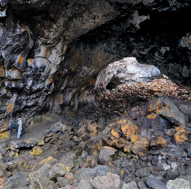 hiker underground in large lava tube