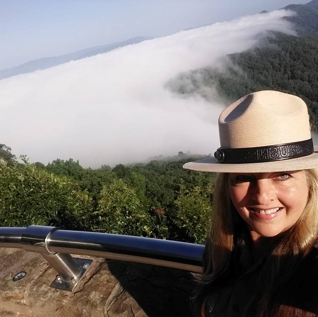 Pamela Eddy standing at a mountain overlook