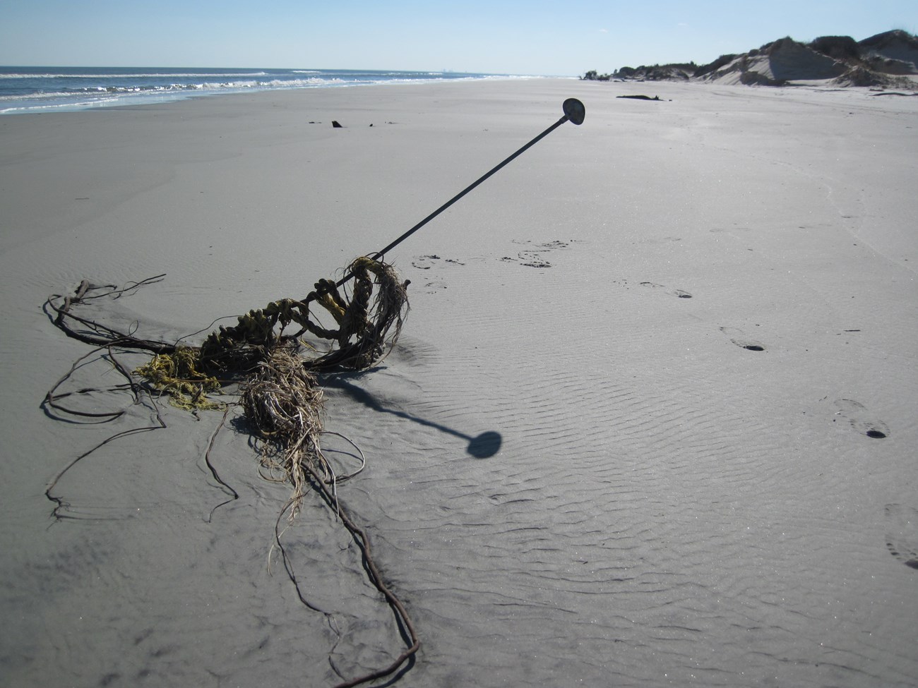 Damaged benchmark sits on the shore.