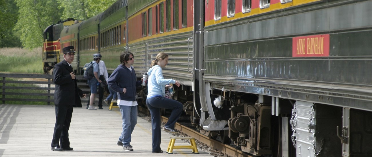 CUVA Train Train conductor and people boarding a train