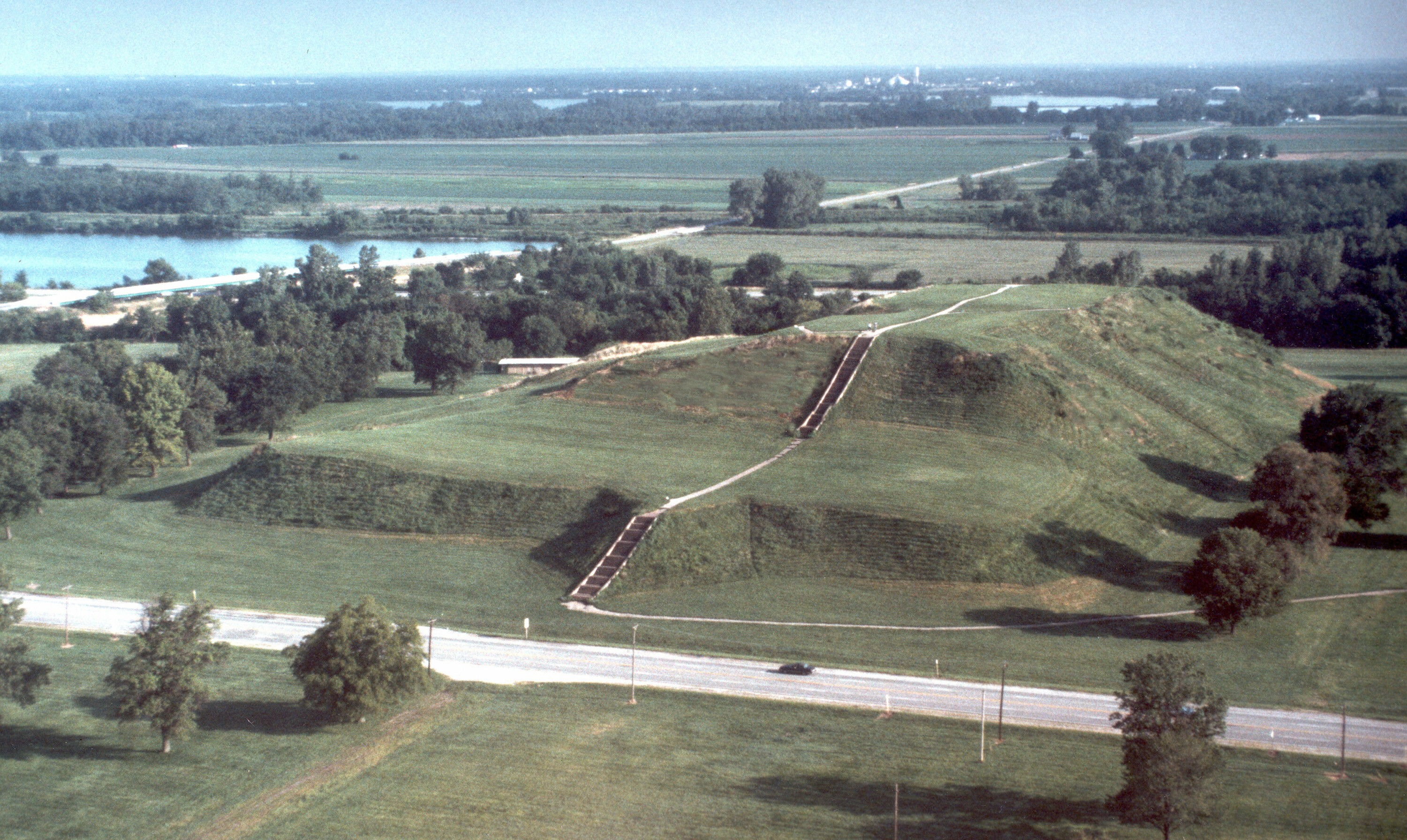 Aerial view of two giant grassy hills.