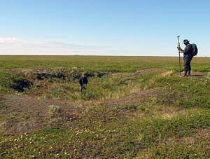 Chris Young (NPS) and U Washington graduate student Shelby Anderson record a previously excavated housepit. (NPS photo)