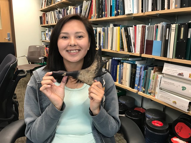 young woman holding a piece of caribou antler