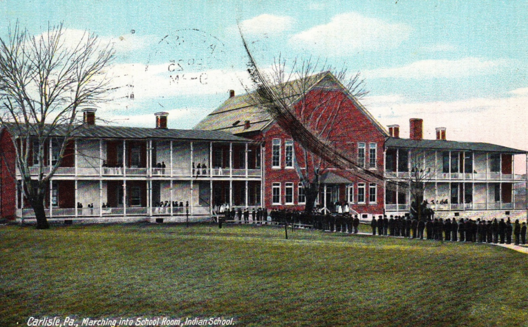 A large building with lines of people outside