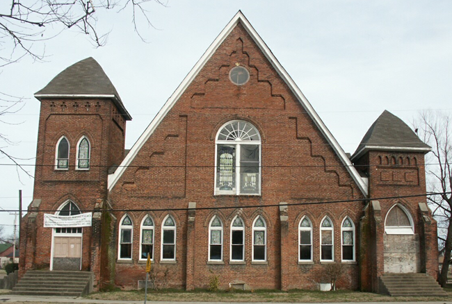 Centennial Baptist Church Brick building with arched windows.