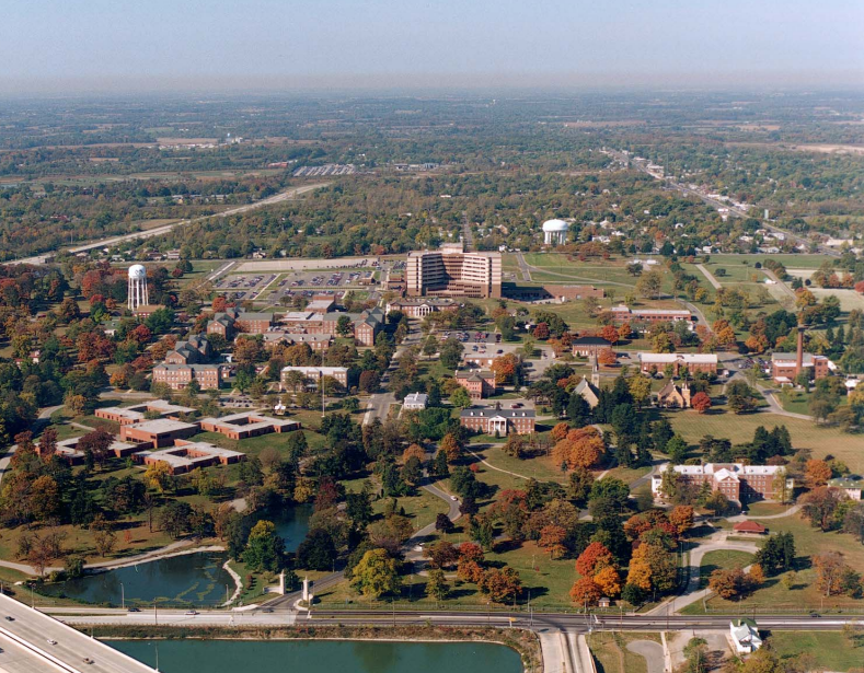 Aerial view of buildings, trees, and lakes.