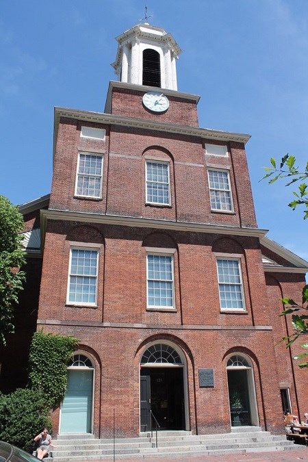 The Charles Street Meeting House, a red brick building with a white, wooden steeple