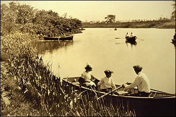 Chicago's Columbus Park B&W photo of people rowing in boats on a lake.
