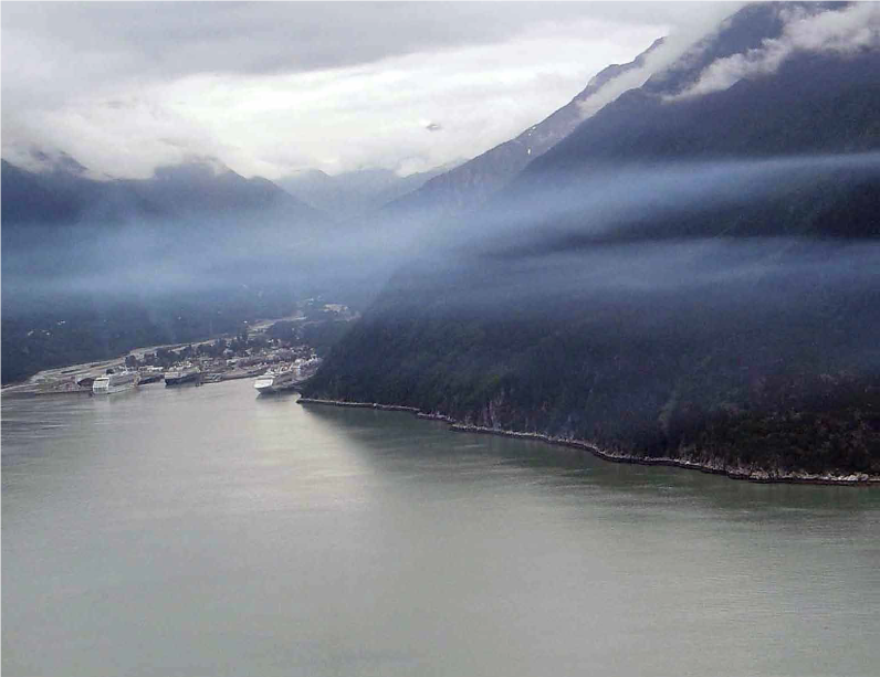 A view about the skagway harbor with a layer of haze about a cruise ship