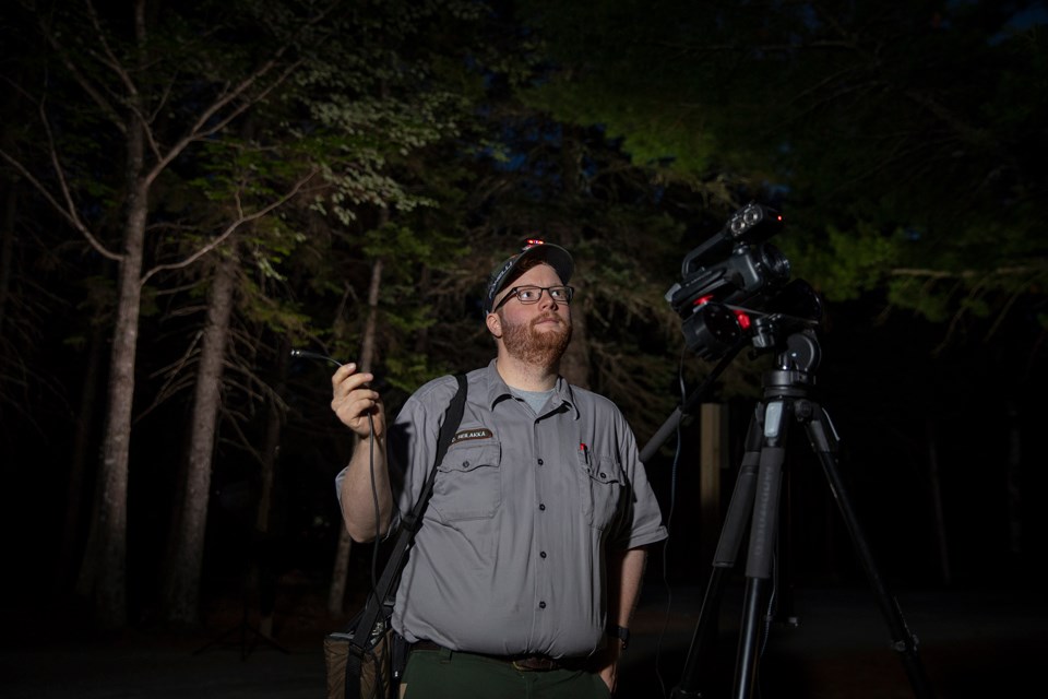 Biologist Biologist with technical equipment in night darkness
