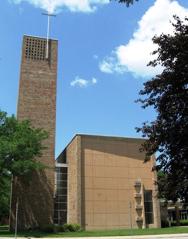 Building with a tower and cross at the top.