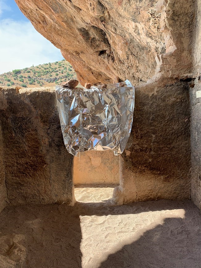 Cliff dwelling doorway wrapped in preparation for wildfire