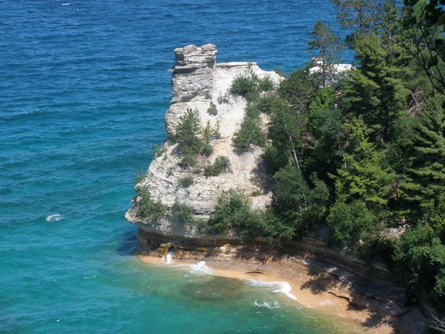 Miners Castle nestled in among the trees along the shoreline