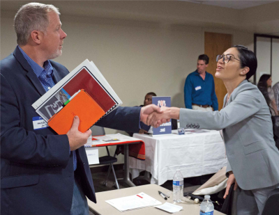 Contracting man and woman shaking hands