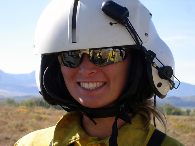Cynthia Worthington A woman in a flight helmet and sunglasses smiles.