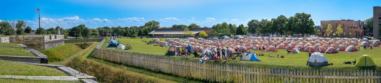 Looking down in to a giant field filled with tents and bicycles.